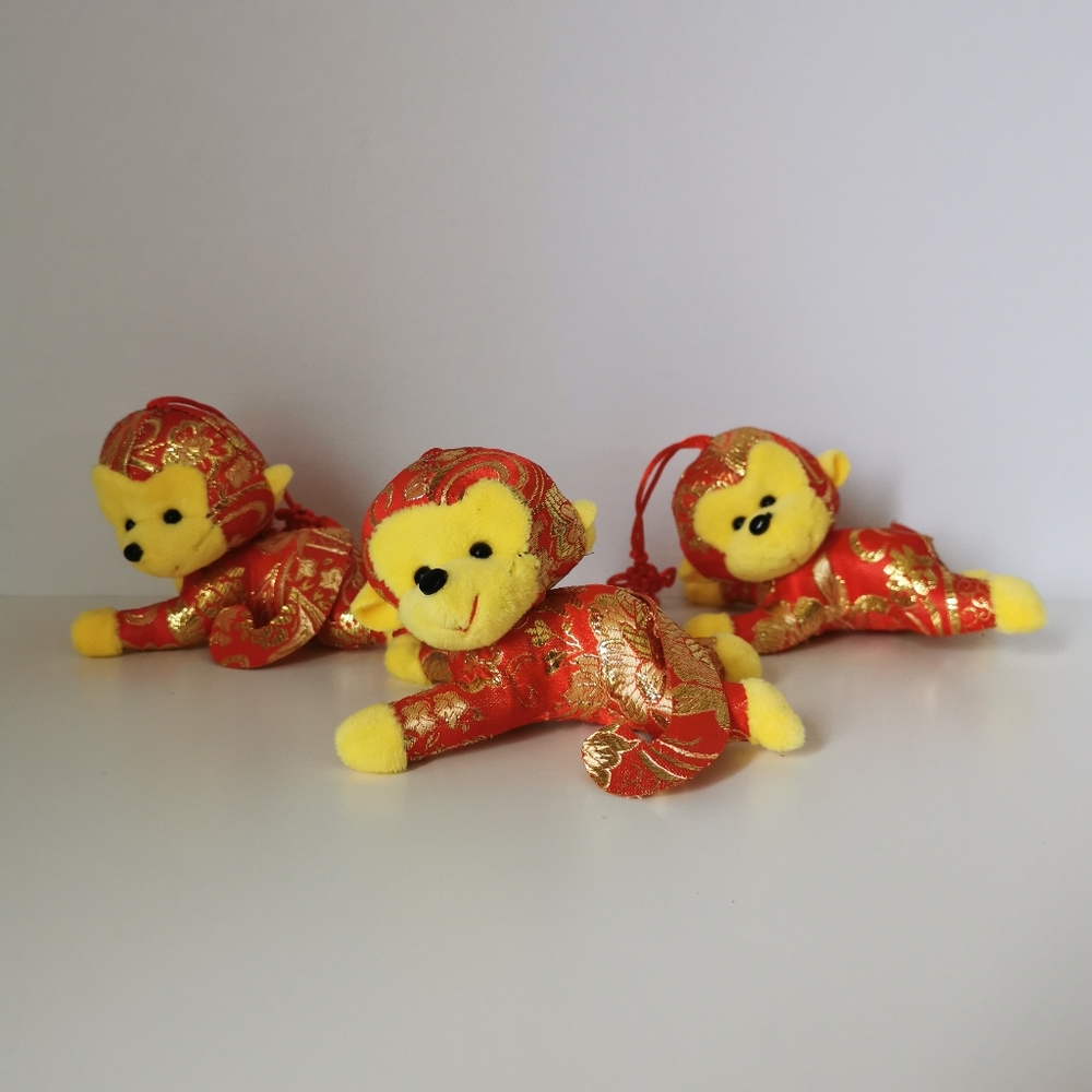 3 small plush monkeys in spring festival costumes